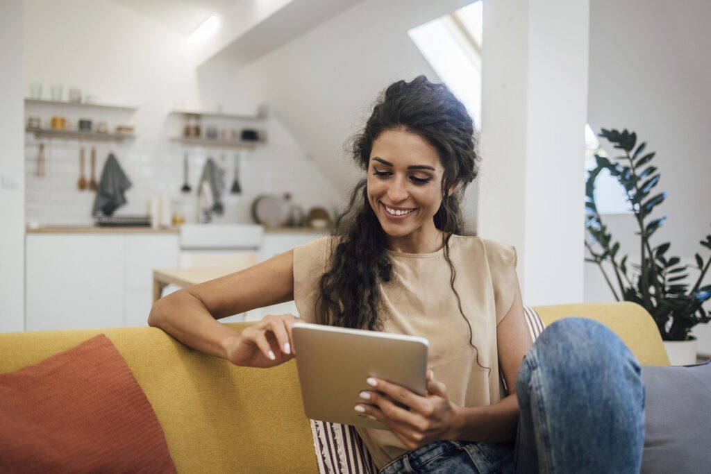 Woman on a tablet filling out a contact form for contacting Petersen Plumbing Services